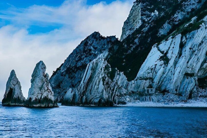 A coastal landscape with rugged cliffs and a calm sea. 2
