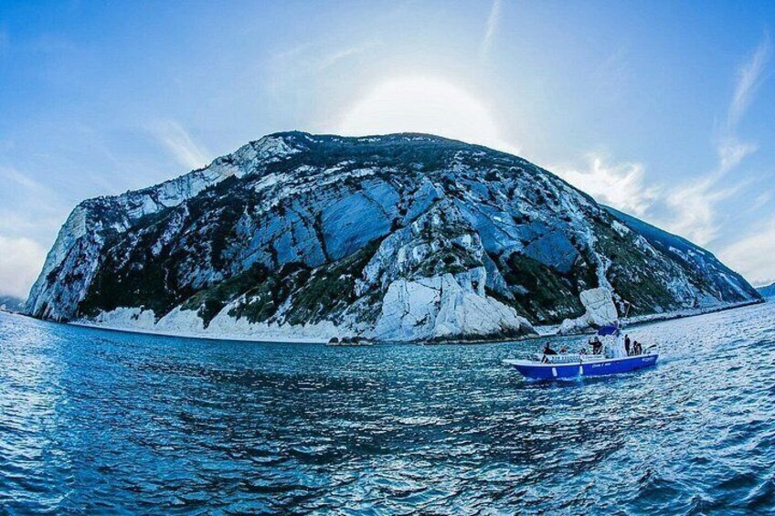 A glacier island with a boat in the water. 3