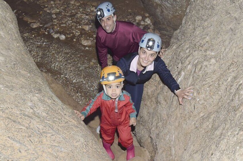 People wearing helmets and climbing a rocky terrain. 1