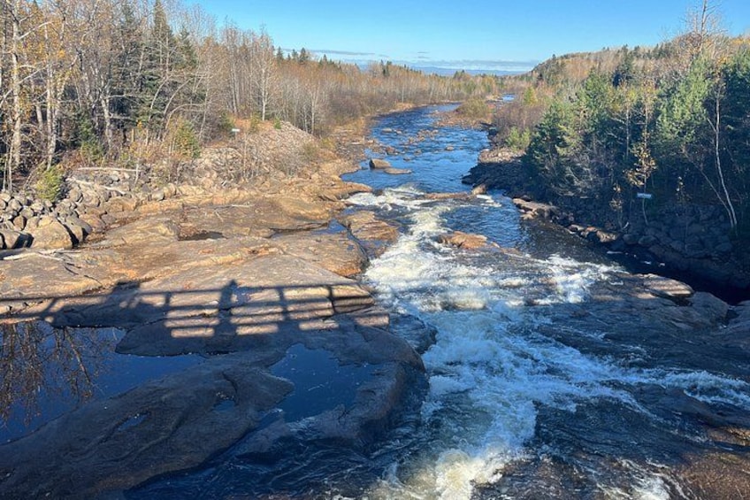A river flowing through a rocky landscape with trees on both sides. 3