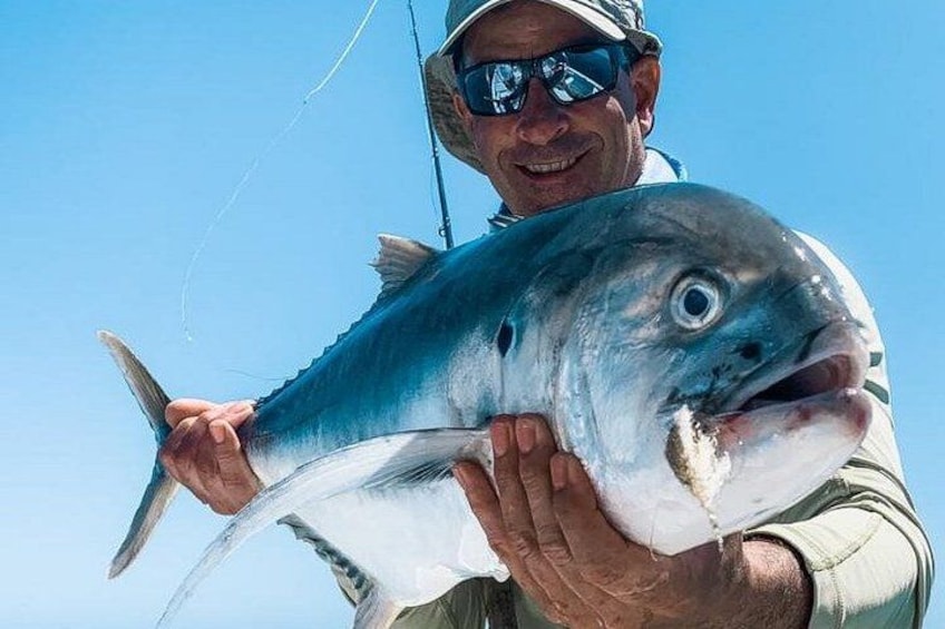 A person holding a large fish. 4