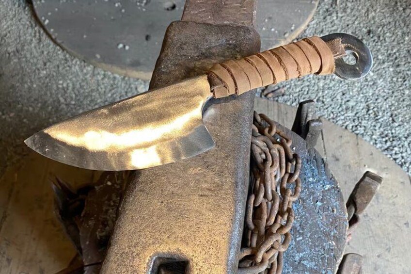 A metal tool with a chain and a handle, possibly a part of machinery or equipment. 2