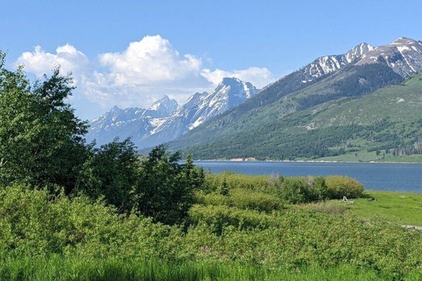 A lake surrounded by mountains and greenery. 5