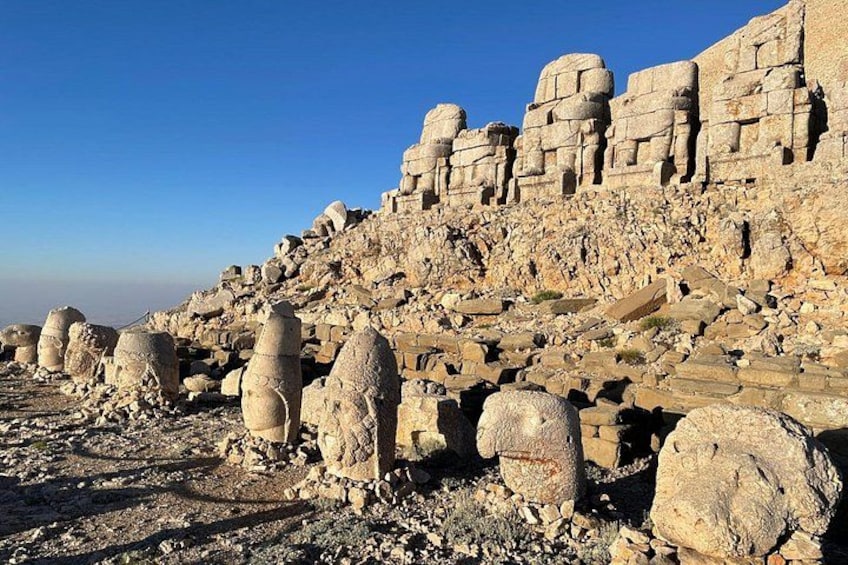 Ancient stone structures and ruins on a rocky hillside. 5