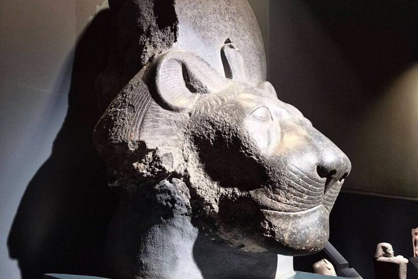 En skulptur i sten som föreställer ett lejonhuvud med ett framträdande öga och ett böjt horn. 4