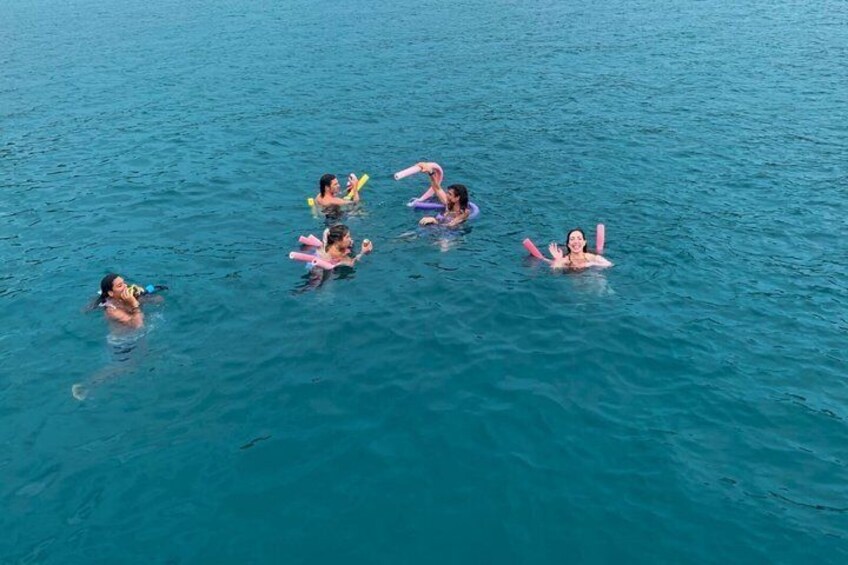 A group of people swimming in a body of water. 3