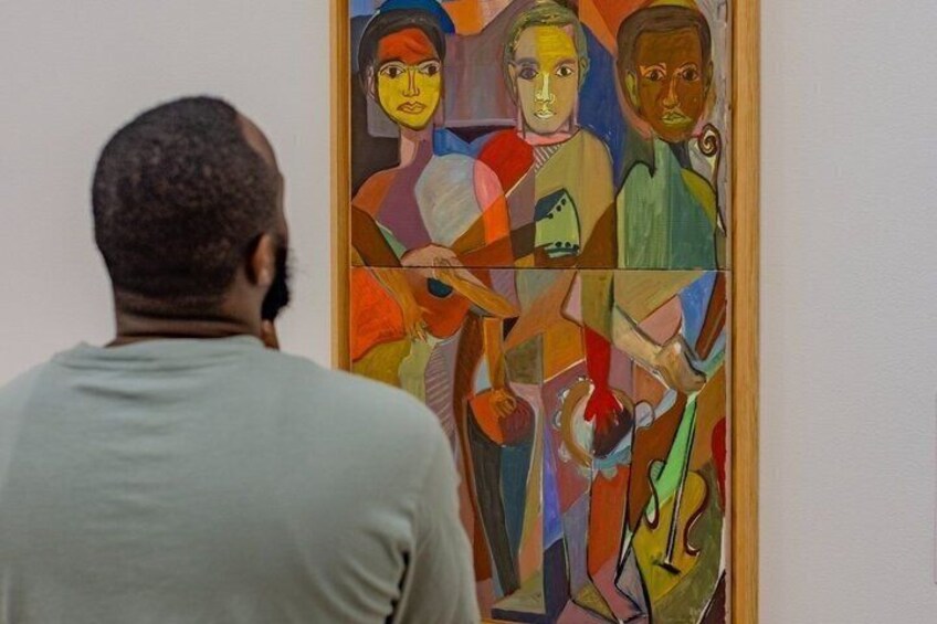 A person viewing a colorful abstract painting. 3