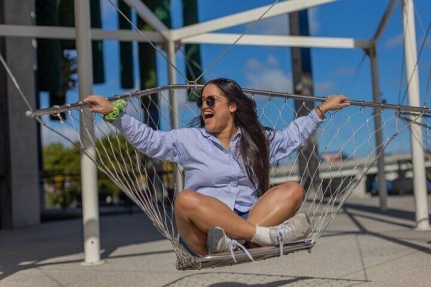 A person sitting in a hammock outdoors. 5