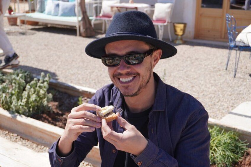A person eating a sandwich outdoors. 4