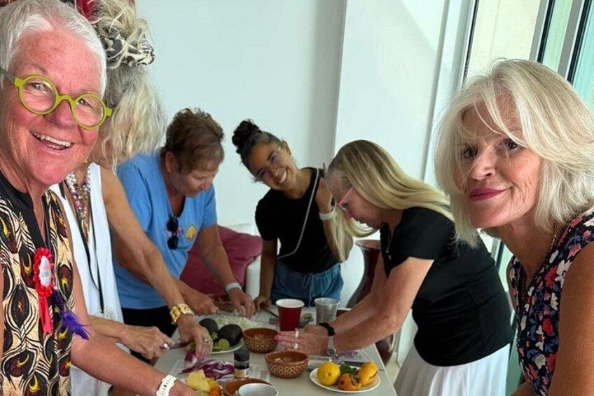 A group of people gathered around a table with food and drinks. 1