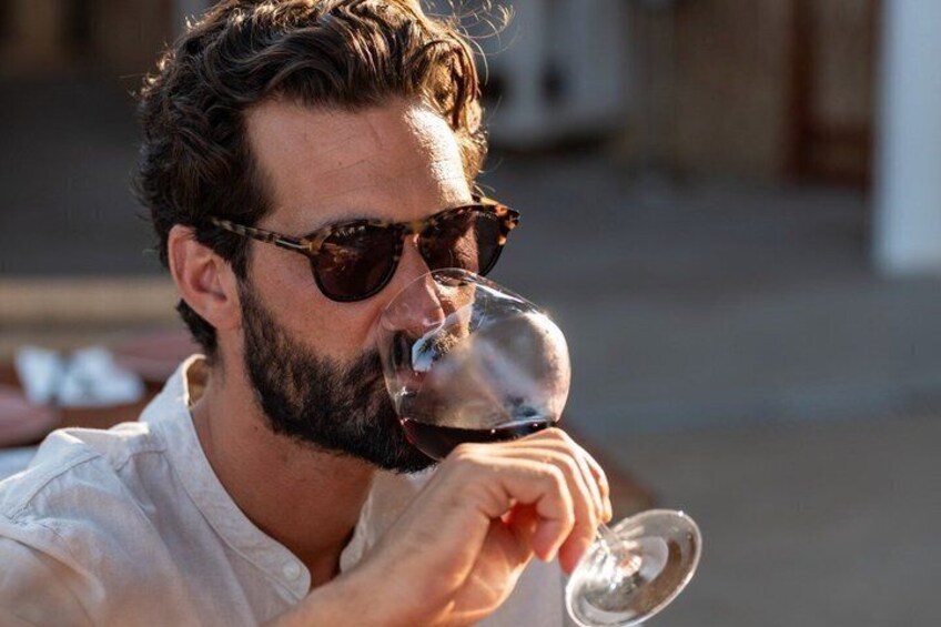 A person holding a wine glass. 5