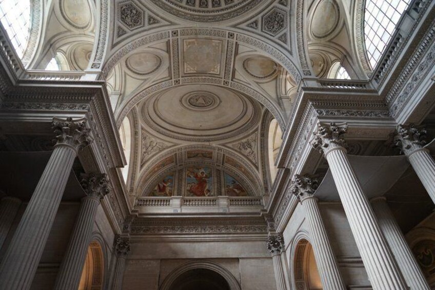 A grand architectural interior with ornate columns, a detailed ceiling, and a central fresco. 2
