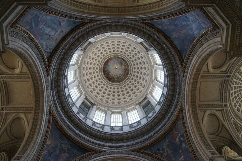 A grand architectural interior with a central dome, ornate columns, and detailed frescoes. 3