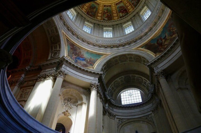 A grand interior with a domed ceiling, columns, and frescoes. 4