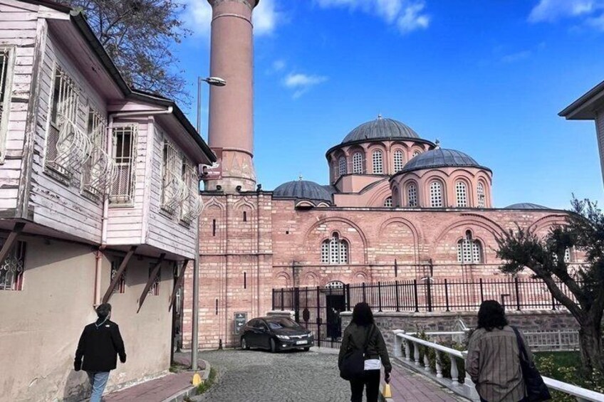 A historic building with domed architecture and a tall chimney. 4