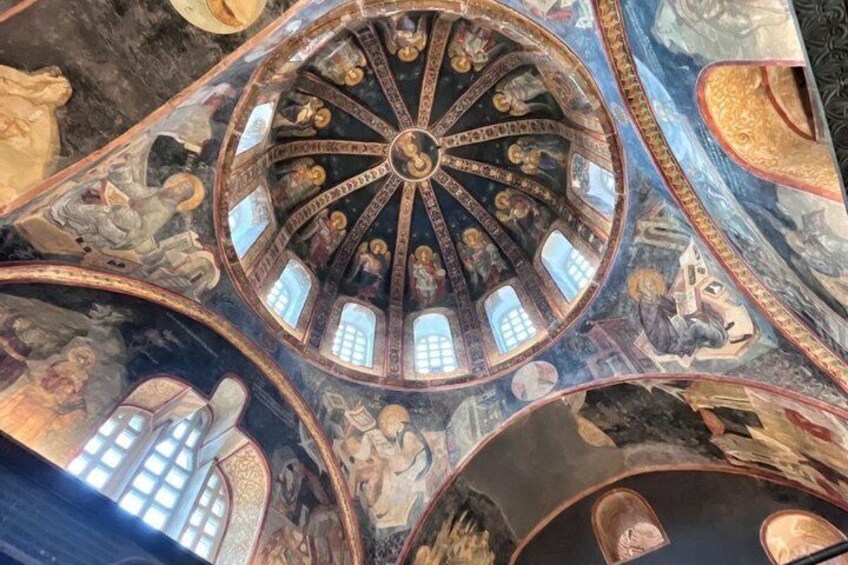 A domed ceiling with intricate frescoes and architectural details. 3