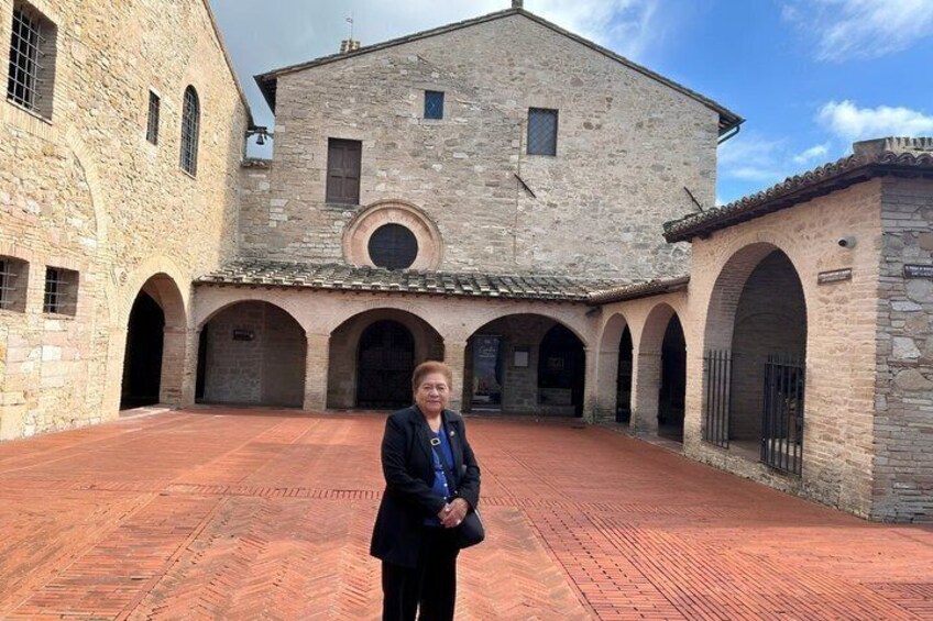 A stone building with arches and a courtyard. 1