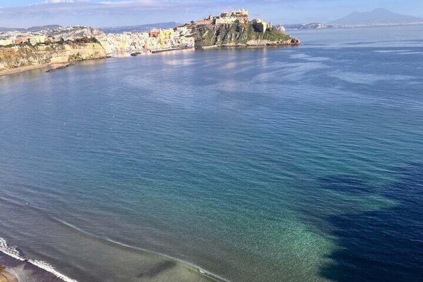 A coastal town with a prominent fort on a cliff overlooking the sea. 5