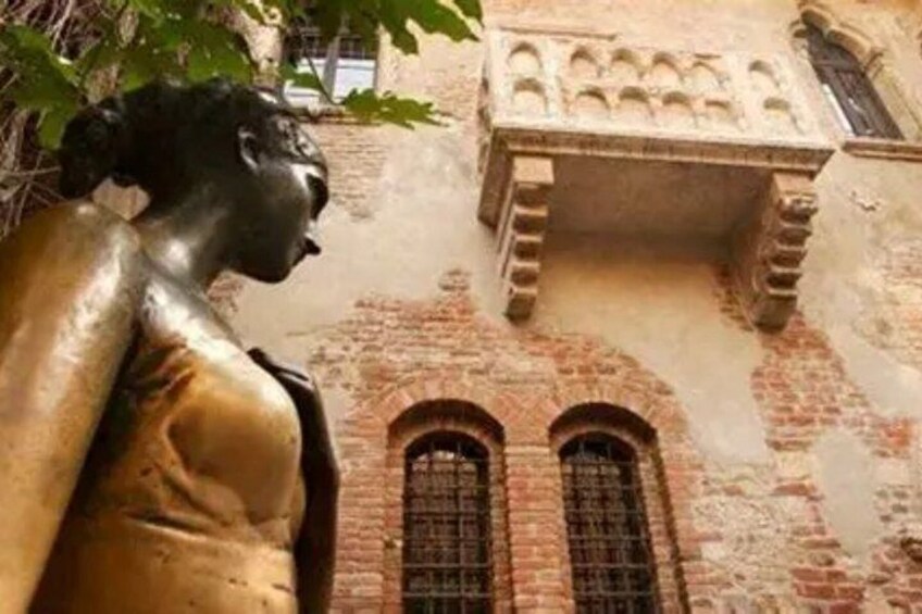 A statue, a brick building, and a window. 4