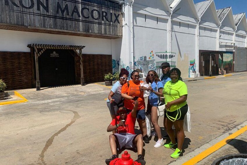 A group of people in front of a building with a sign that reads 'MACORIX.' 5