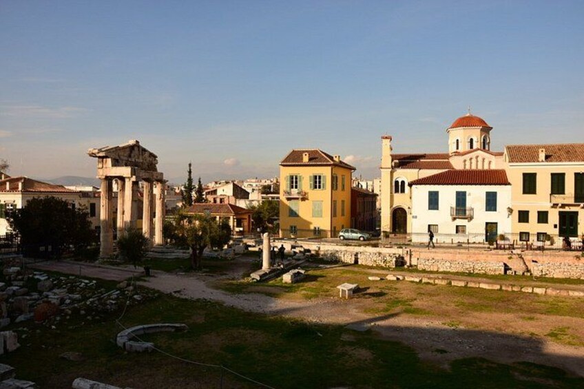 Ancient ruins, a church, and colorful buildings in a historic town. 1