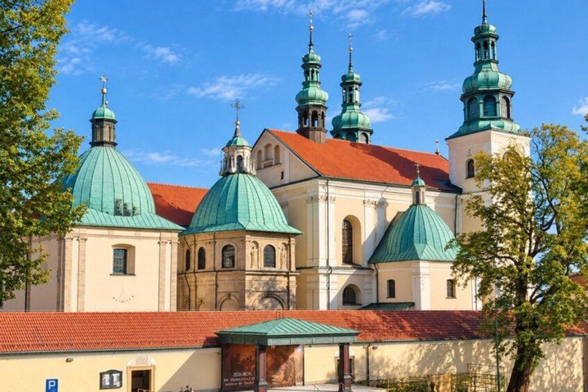 A church with green domes and red-tiled roofs. 3