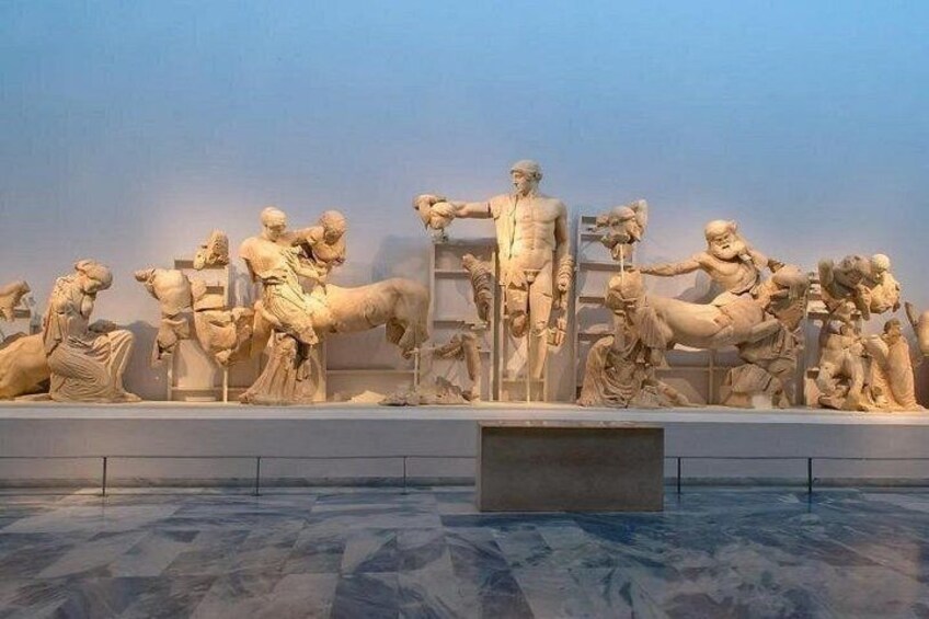 A marble sculpture of a historical battle scene with multiple figures in dynamic poses. 5