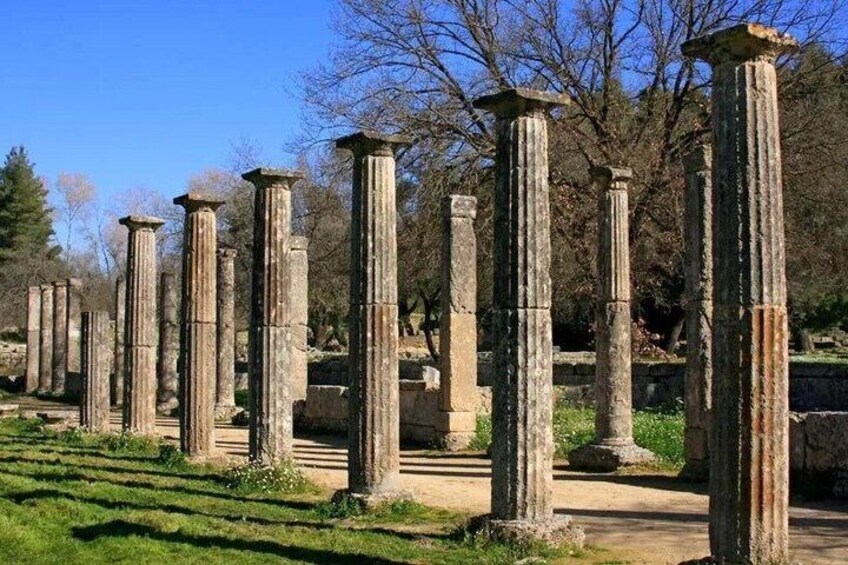 Ancient stone columns in a park setting. 3