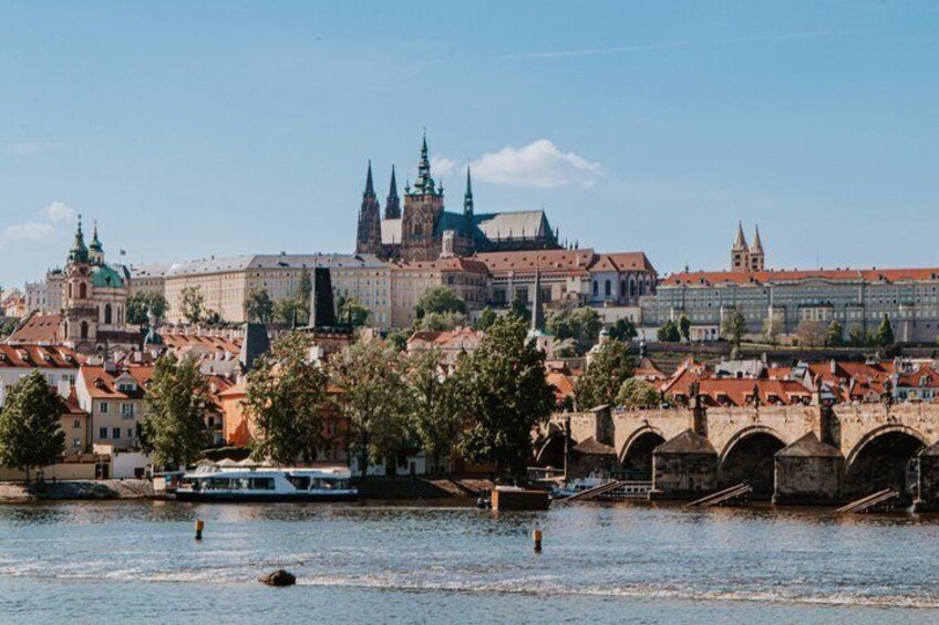 A river with a bridge, historic buildings, and a prominent cathedral with spires. 4