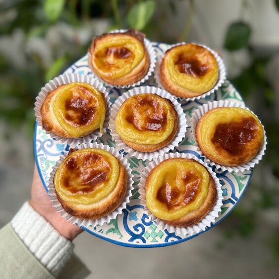 A plate of six Portuguese egg tarts. 5