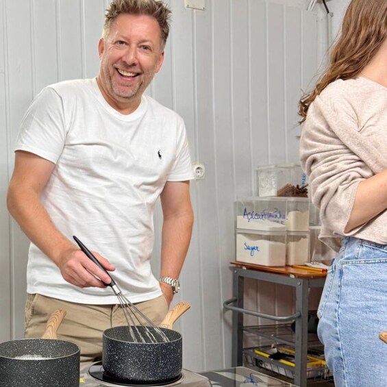 A person cooking with a whisk in a kitchen. 4