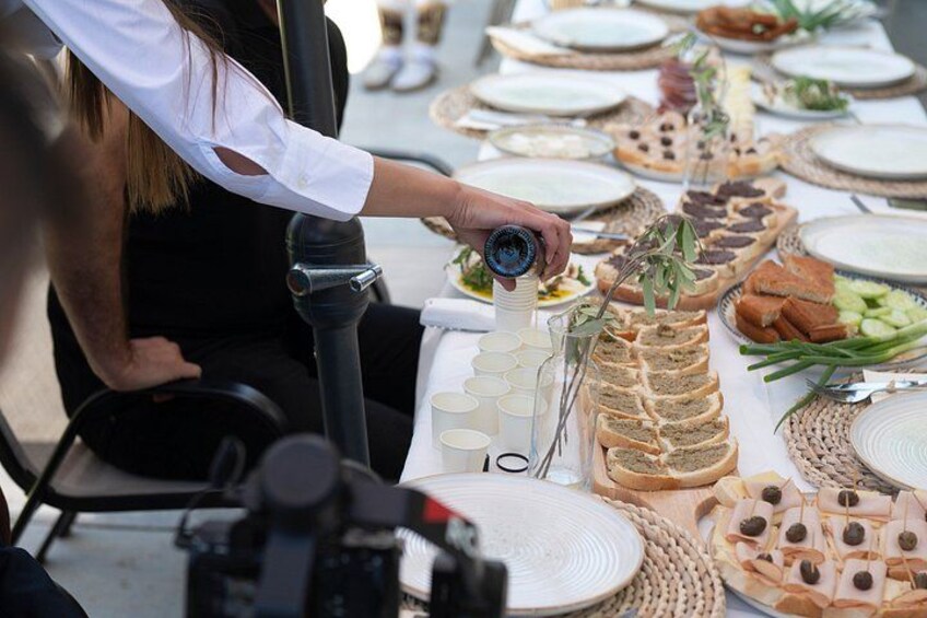 A person arranging food on a table with various dishes and utensils. 5
