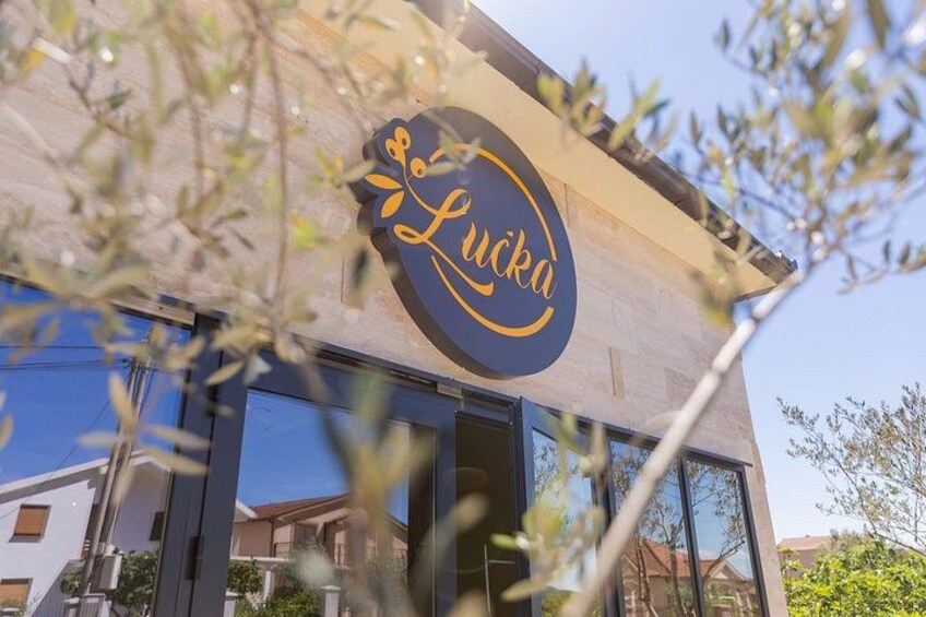 A building with a sign that reads 'Lucka.' 3