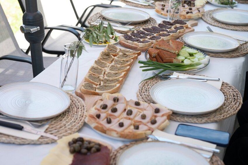 A table set with plates, cutlery, and various food items. 2