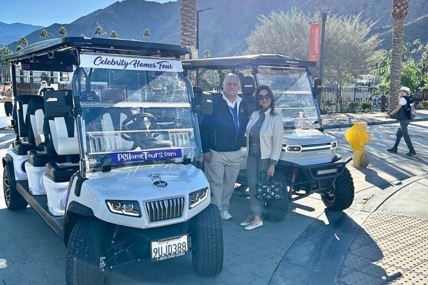 A Celebrity Homes Tour vehicle parked on a street with palm trees and mountains in the background. 4