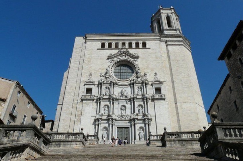 A large, historic building with a prominent clock tower and detailed facade. 2