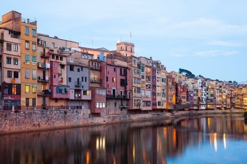 A waterfront with colorful buildings reflecting on the water. 5