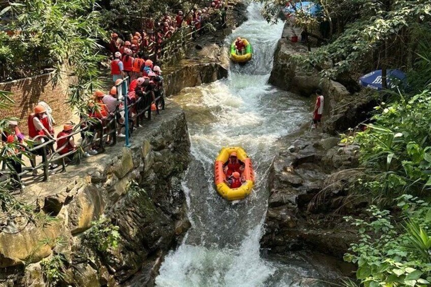 A river with rapids, rafts, and people in safety gear. 2