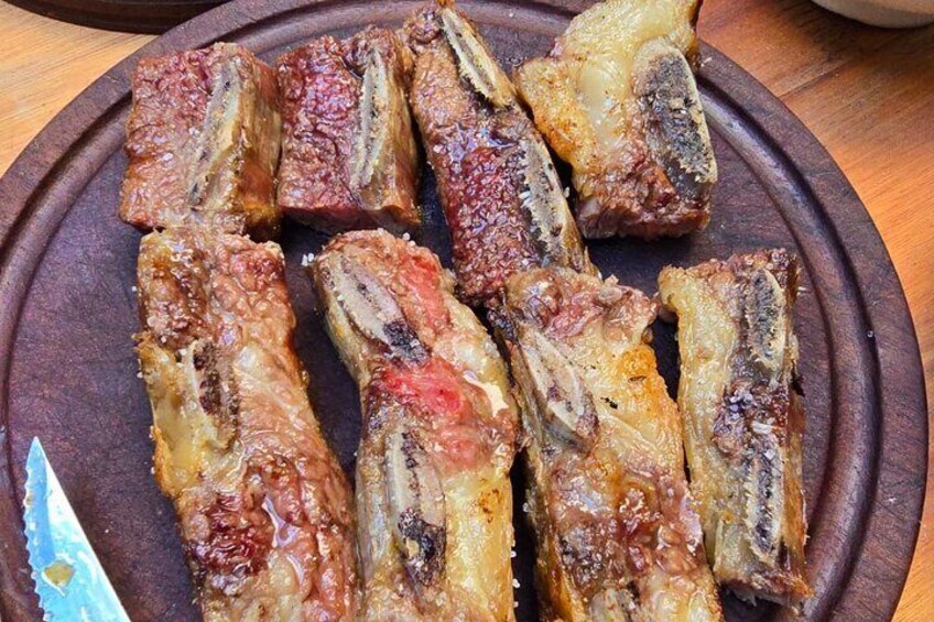 Roasted pork ribs on a wooden plate. 4