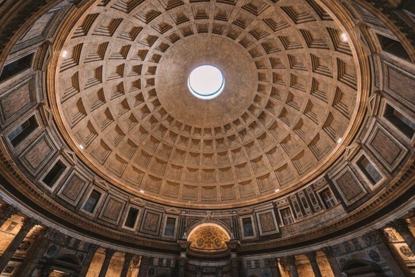A grand, circular architectural ceiling with a central skylight. 2