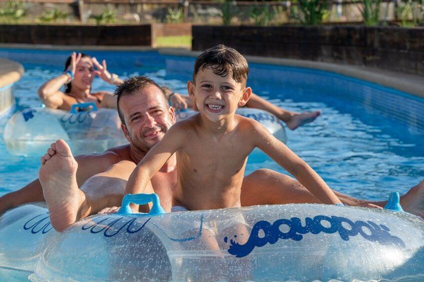 A swimming pool with inflatable rings and people floating in the water. 1