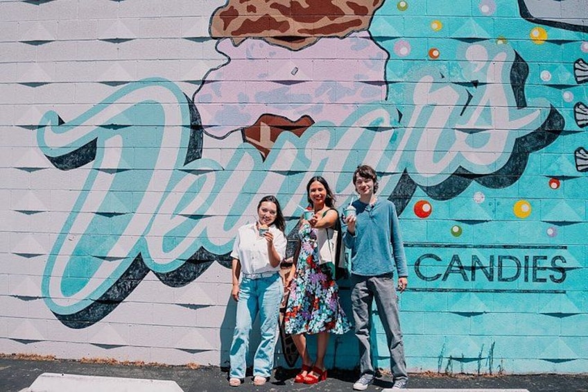 A mural with the word 'Candies' and a person standing in front of it. 5