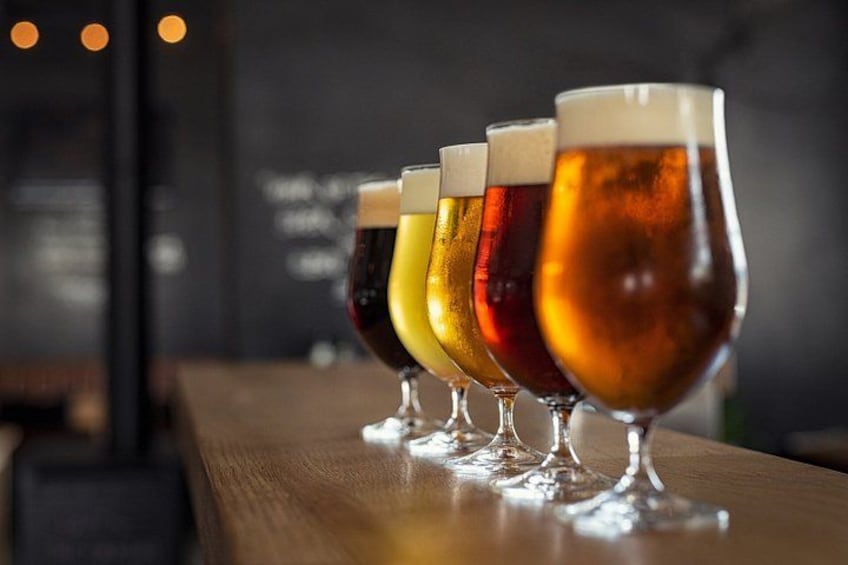 A row of beer glasses on a bar counter. 2