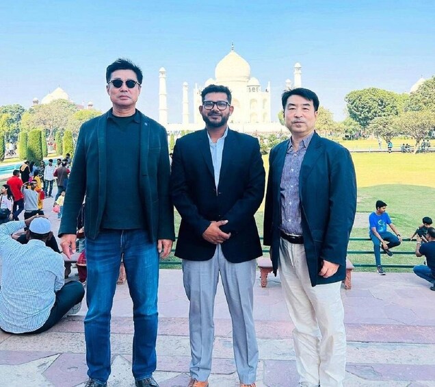 Three men standing in front of the Taj Mahal. 2
