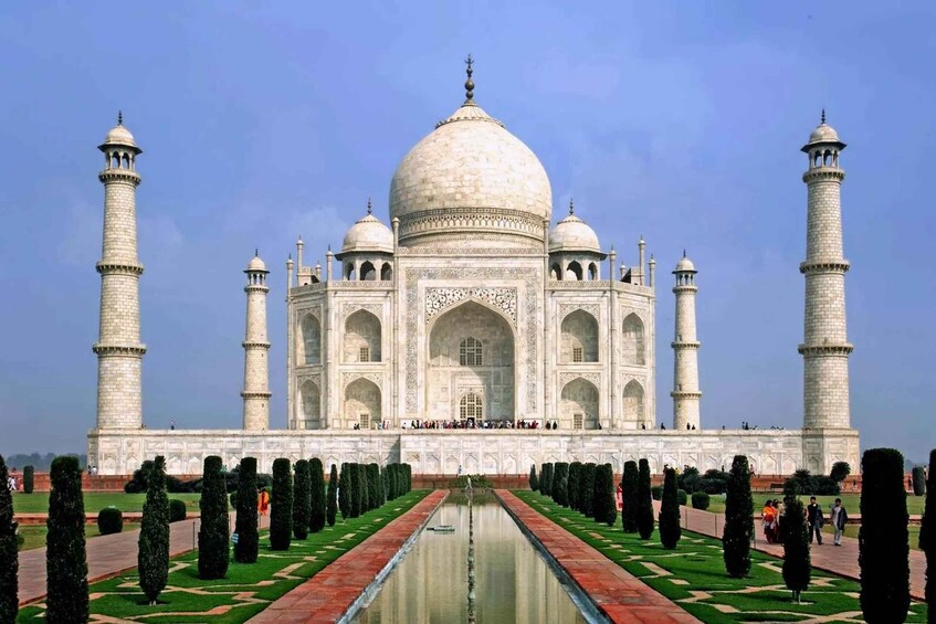 The Taj Mahal with four minarets, a central dome, and a reflection in the water. 2