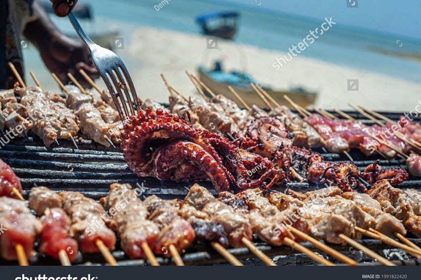 Skewered meats grilling on a barbecue. 4