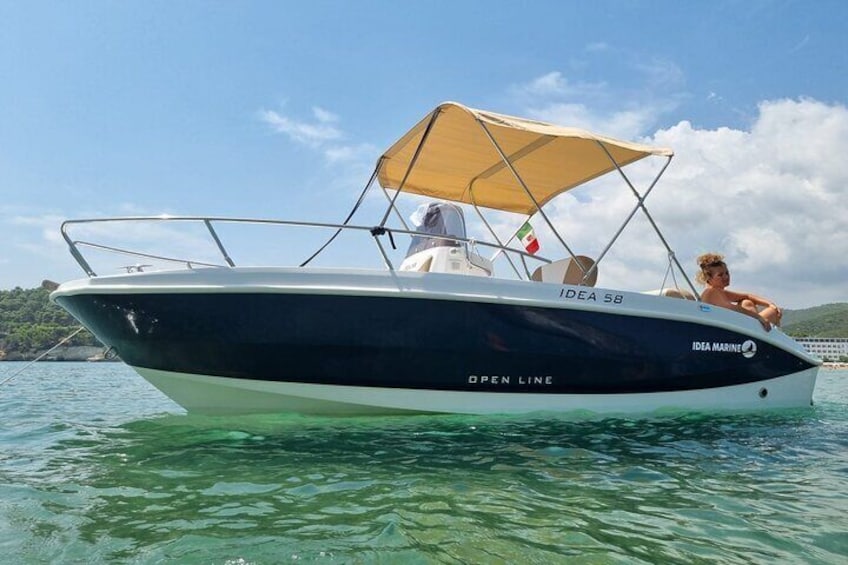 A boat named 'IDEA 58' with a canopy, labeled 'IDEA MARINE' and 'OPEN LINE,' on clear water. 1
