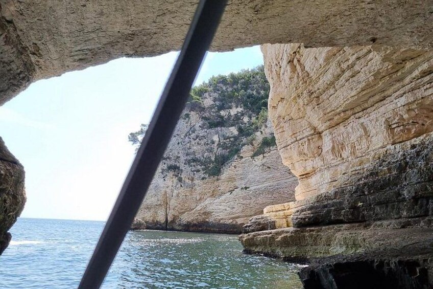 A rocky coastline with layered cliffs and calm sea. 4