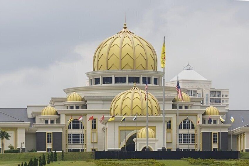 A large building with multiple golden domes and flags. 5