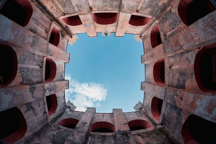 A circular stone structure with multiple openings. 4